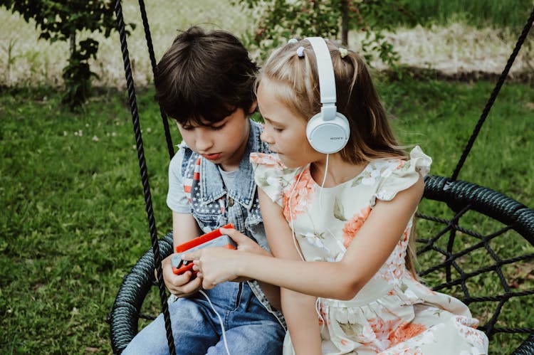 Content Children Listening To Music On Playground