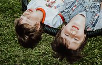 Content boys lying on swings