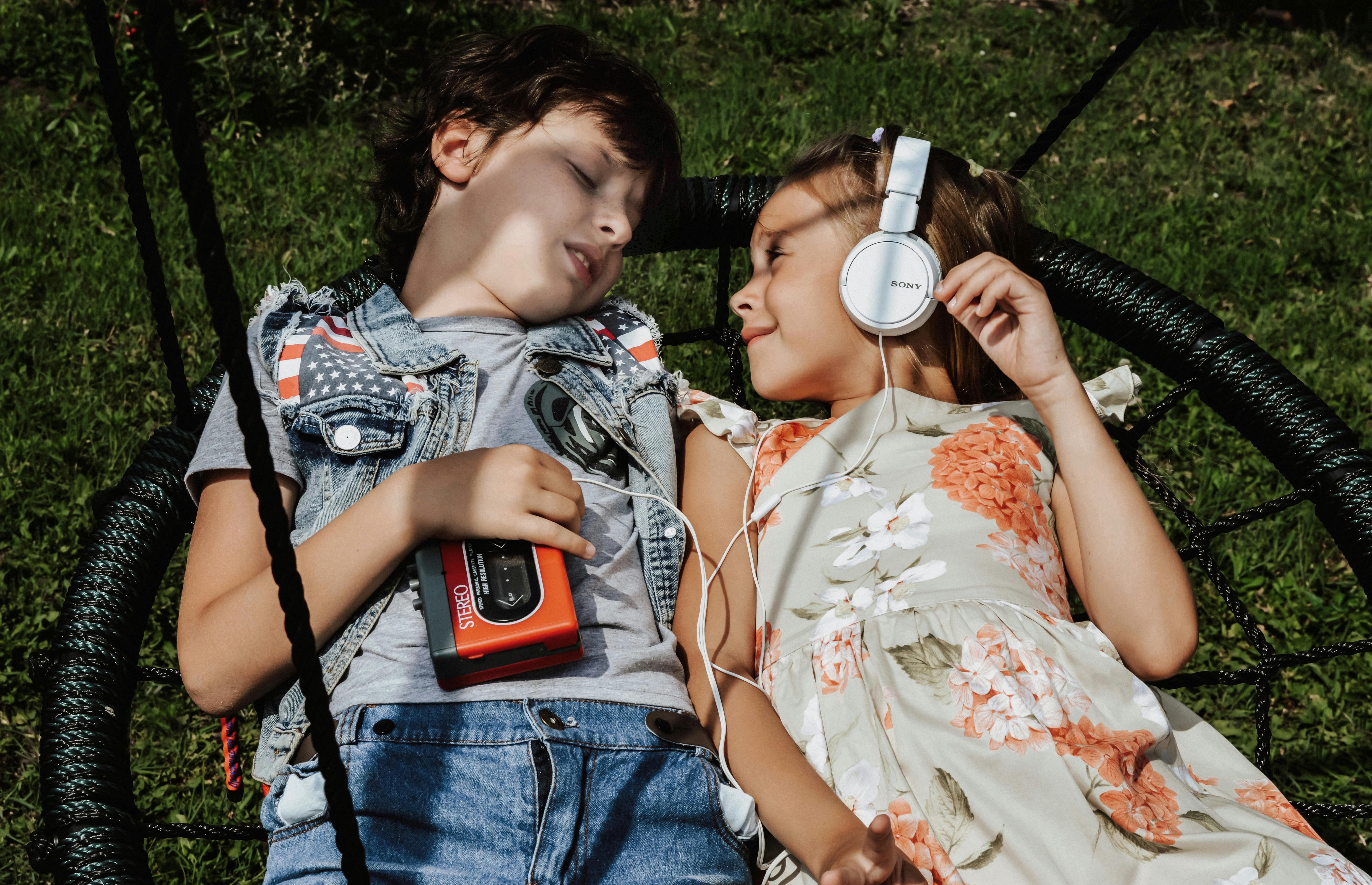 content kids listening to music on swing