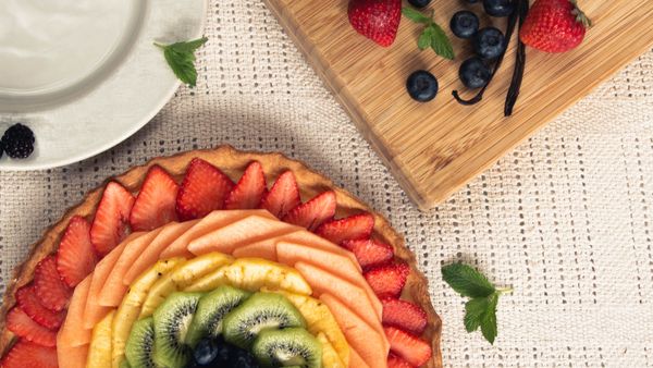 Stone fruit tart on a board — photo by Regina Ferraz on Pexels