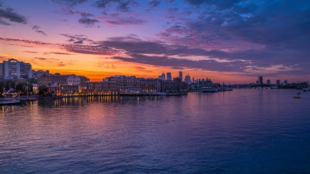 Beautiful sunrise over London skyline, reflecting in the Thames River.