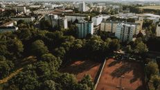 Cityscape with sports ground and tall houses