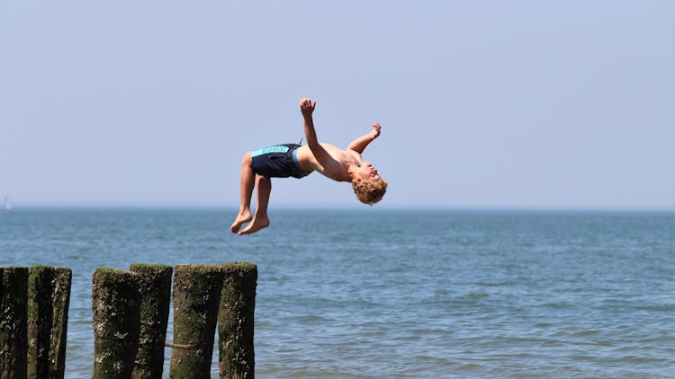 Shirtless Man Doing A Backflip