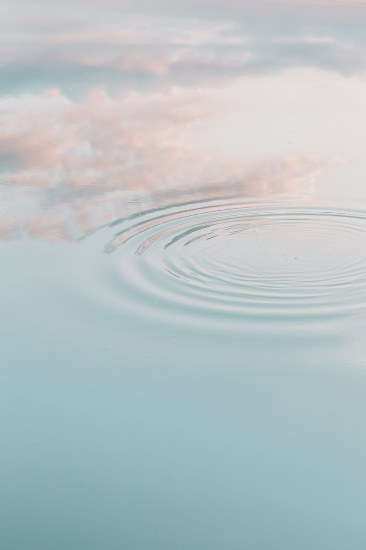 Ripples On Water Surface Reflecting Clouds