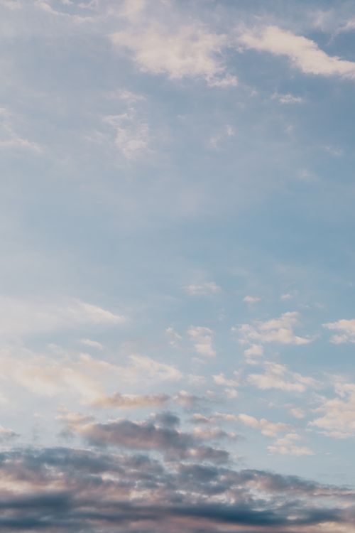 Free Tranquil blue sky with scattered white clouds creating a peaceful atmosphere. Stock Photo
