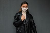 Woman in Black Leather Jacket Wearing White Face Mask