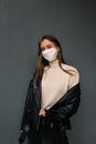Woman in White Turtleneck Shirt and Black Leather Jacket