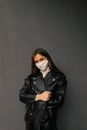 Woman in Black Leather Jacket Standing Beside Black Wall