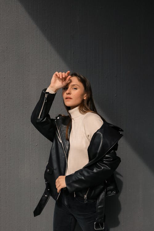 Woman in Beige Turtleneck Sweater and Black Leather Jacket