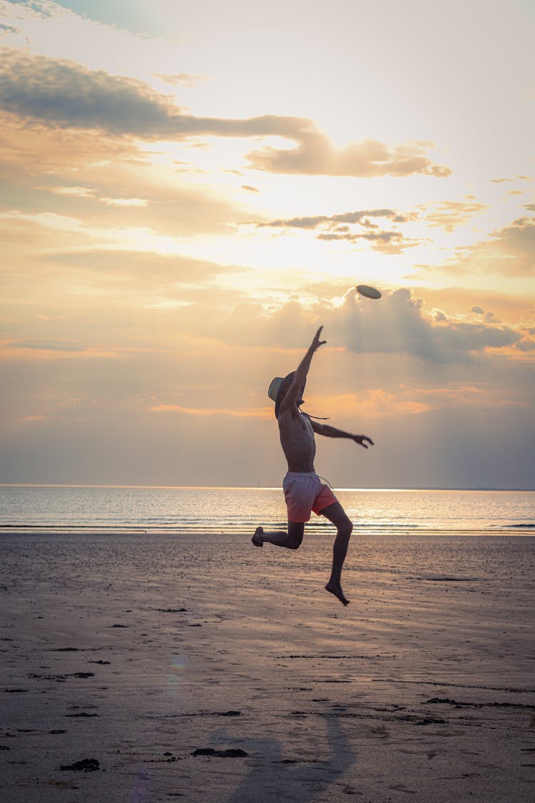 Man At The Beach Playing Frisbee 