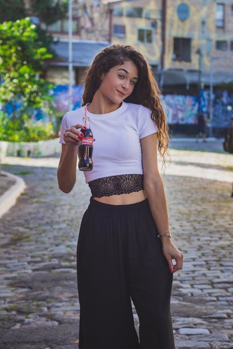 Woman In White And Black Tank Top Holding A Bottle Of Softdrink