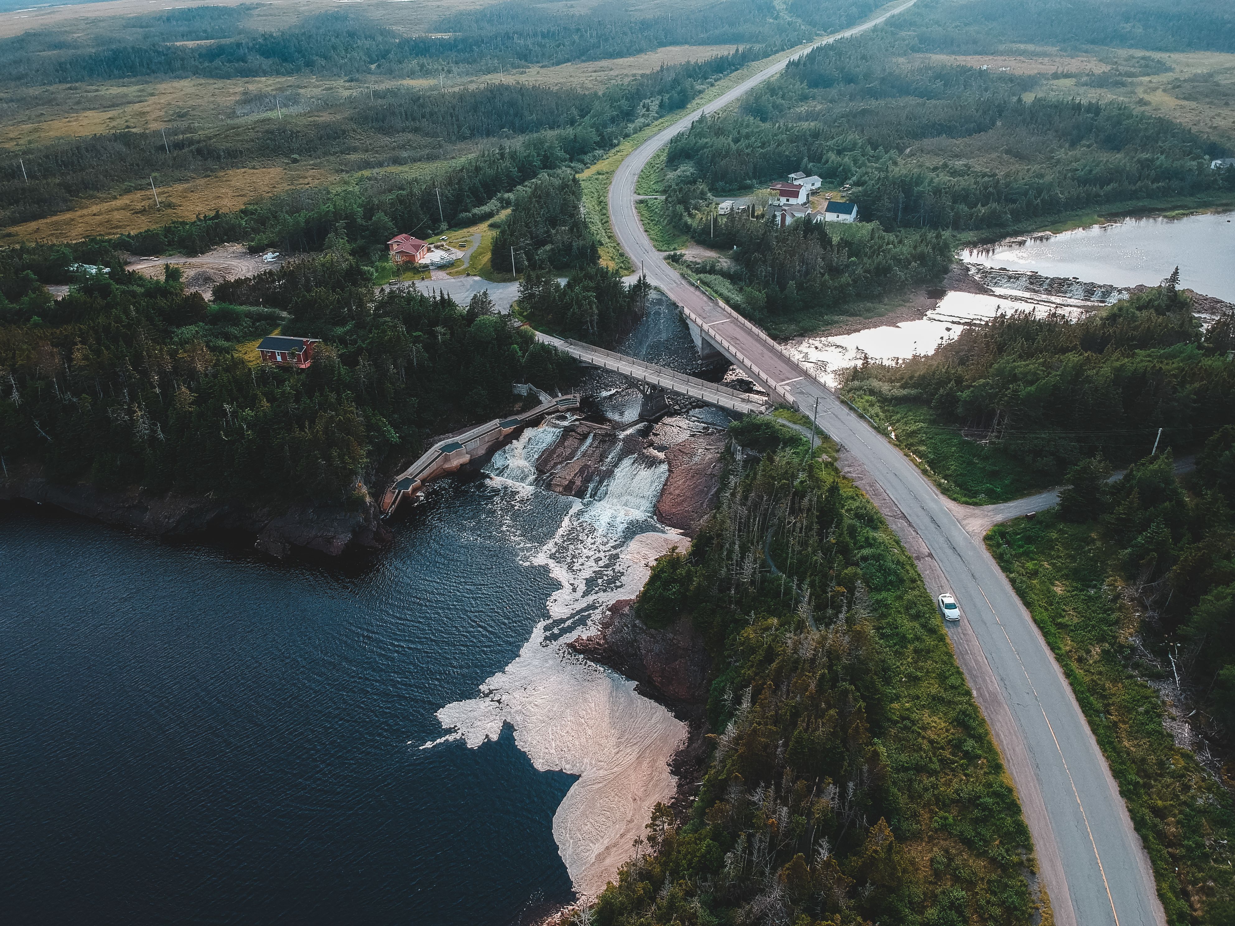 Outstanding 20 km Helicopter Tour over Toronto Review: Soaring Above Canada's Iconic Skyline Review 2026 - Aerial view of roadway with bridge above river with waterfalls and sea near greenery trees in mounts