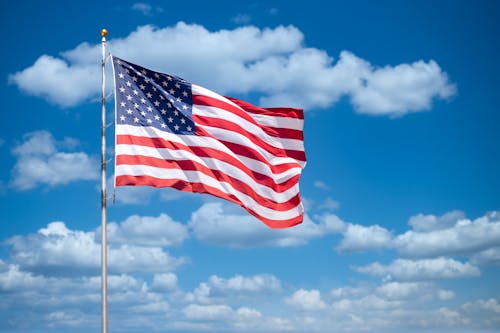 Free USA flag on blue sky Stock Photo