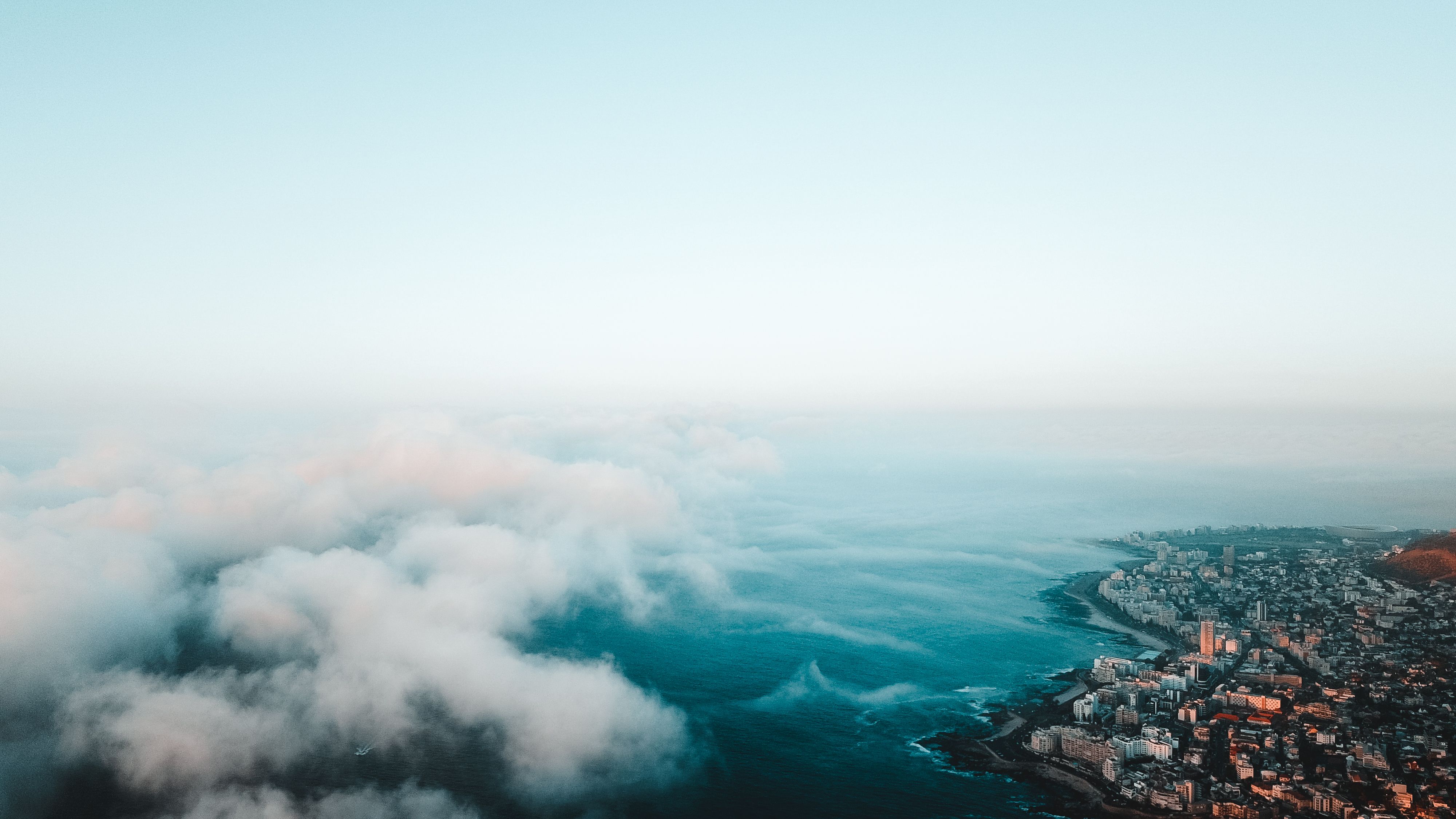 Breathtaking Two Oceans Scenic Helicopter Flight Tour from Cape Town Review Review 2026 - Breathtaking aerial view of Cape Town's coastline with fluffy clouds and cityscape.