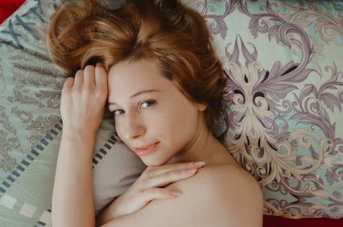 Free Gentle woman lying on bed Stock Photo