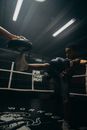 Man in Black Tank Top and Black Shorts Holding Black and White Boxing Gloves