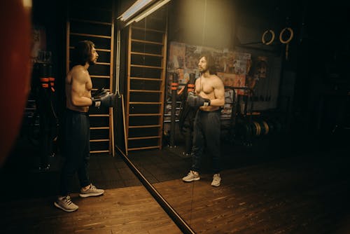 Man in Black Pants Holding Black Exercise Equipment