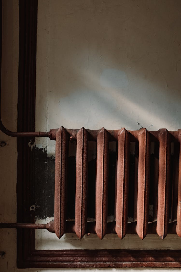 Rusty Steam Radiator On Wall 