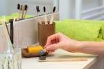 Person Holding Brown Wooden Rolling Pin