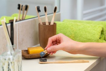 Person Holding Brown Wooden Rolling Pin