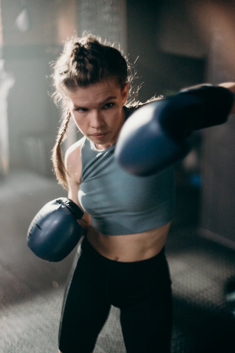 Woman In Blue Sports Bra And Black Leggings Doing Exercise