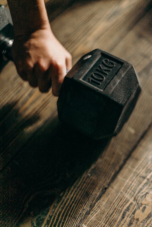 Free Black Dumbbell on Brown Wooden Table Stock Photo