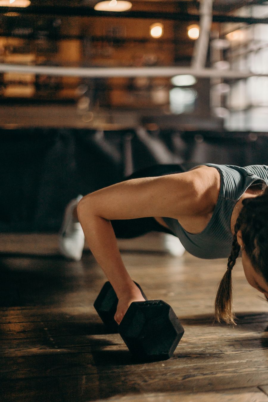 Woman doing a dumbbell home workout for PCOS
