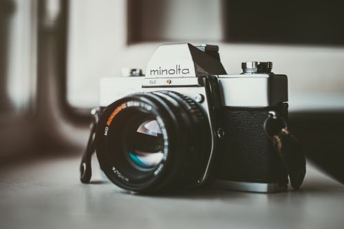 Free Close-up of a classic Minolta film camera showcasing its elegant design and lens details. Stock Photo