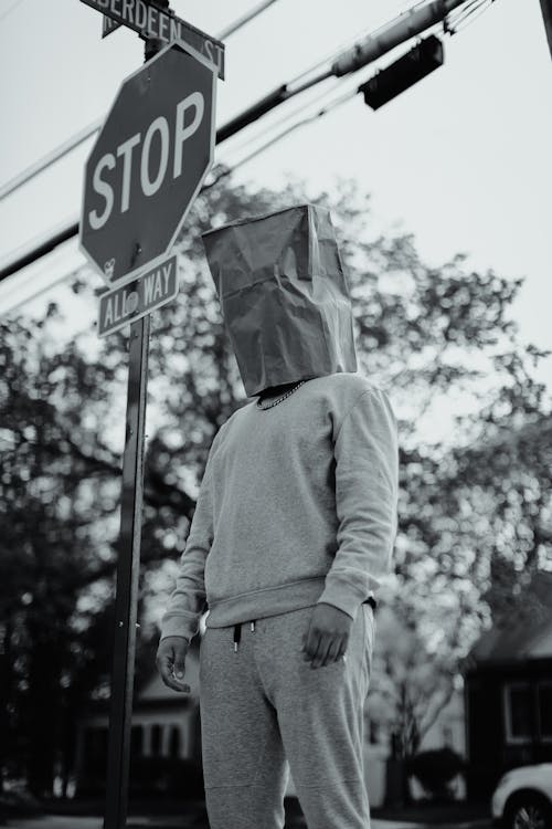 Grayscale Photography of Man with Paper Bag on His Head