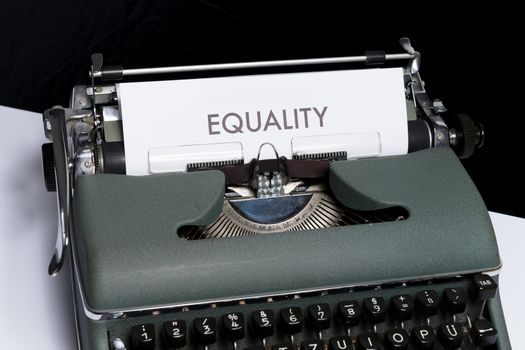 Close-up of a vintage typewriter with the word 'Equality' typed on paper, symbolizing equality and inclusivity.