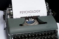 Green and Black Typewriter With White Printer Paper