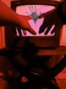 A Person Reaching Out to a CRT Television