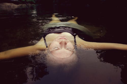 Free Woman Floating on Water Stock Photo