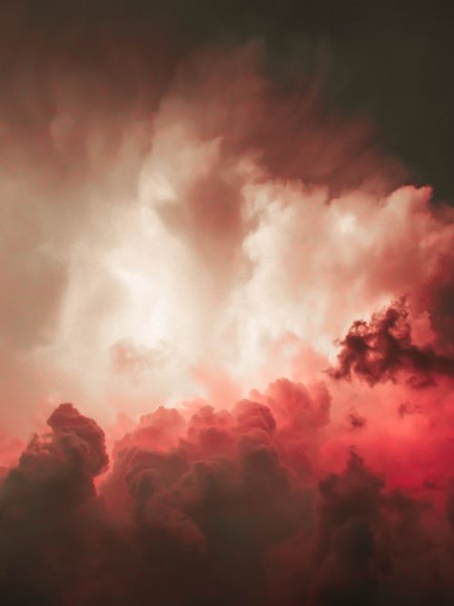 Free A captivating image of vibrant red clouds against a darkening sky, creating a dramatic sunset scene. Stock Photo