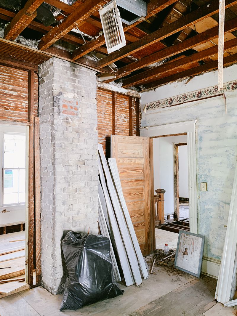 Interior heritage building renovation with timber beams and rough finishes