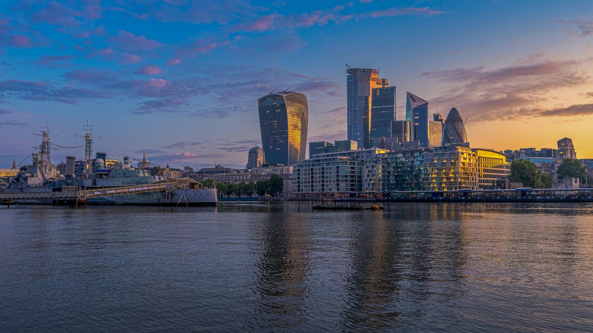 Breathtaking view of the London skyline with modern architecture and waterfront at sunset.