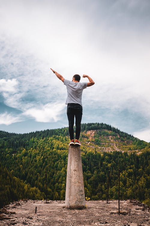 Free Man Standing on a Pedestal Stock Photo