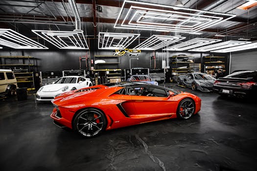 High-end sports cars displayed in a sleek, modern showroom with stylish lighting.