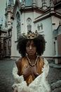 Black woman in crown against cathedral