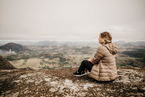 Woman enjoying view of mountainous terrain