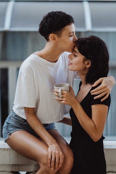 Romantic embrace of a happy lesbian couple sharing a tender moment outdoors.
