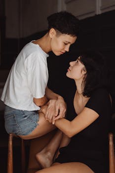 A tender and affectionate moment captured between a lesbian couple in a relaxed setting.