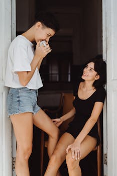 Two women share a tender moment at a doorway, exuding warmth and affection.