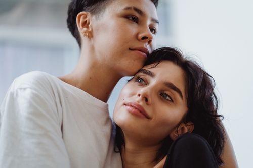 Free Intimate portrait of a couple embracing with affection indoors. Stock Photo