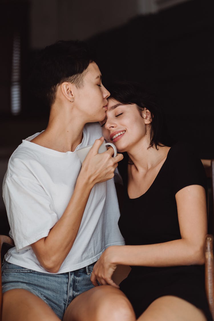 Affectionate Couple During Kiss On Forehead