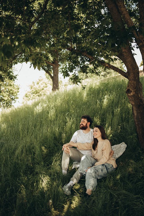 Man and Woman Sitting on Grass