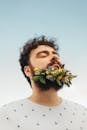 Man in White Crew Neck Shirt Holding Bouquet of Flowers