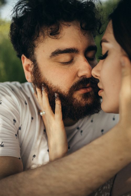 Free Intimate moment between a couple outdoors, showing affection and love. Stock Photo