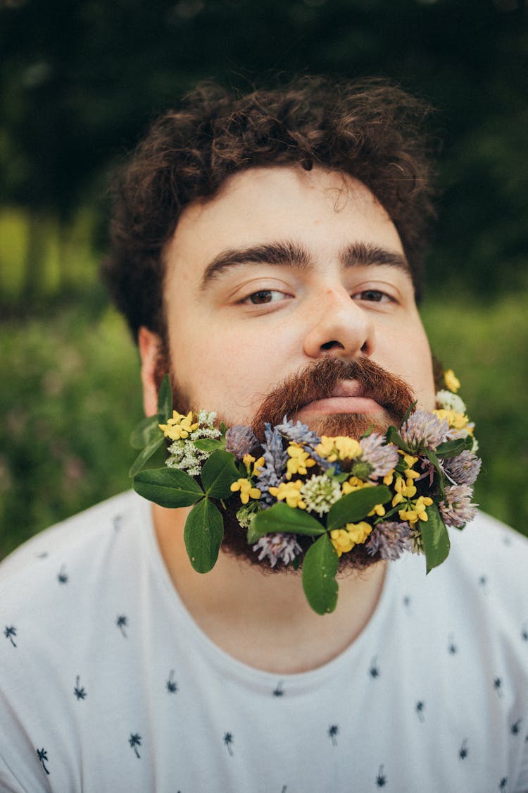 Close Up Photo Of A Man With Flowers On Beard