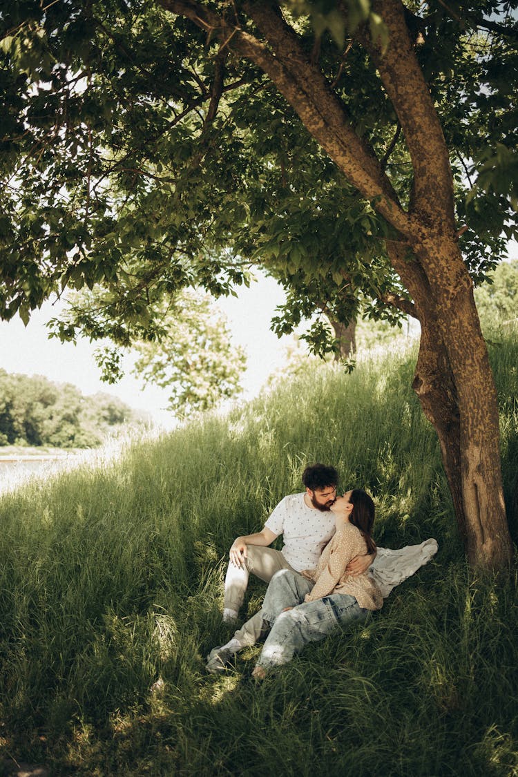 Couple Sitting Under The Tree